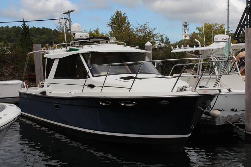 The Image of 2013 Cutwater 28 LE boat docked in a marina, surrounded by other vessels. - 0