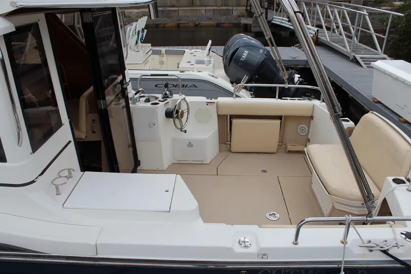 Slide: The Image of 2013 Cutwater 28 LE boat interior with seating and steering area. - 11