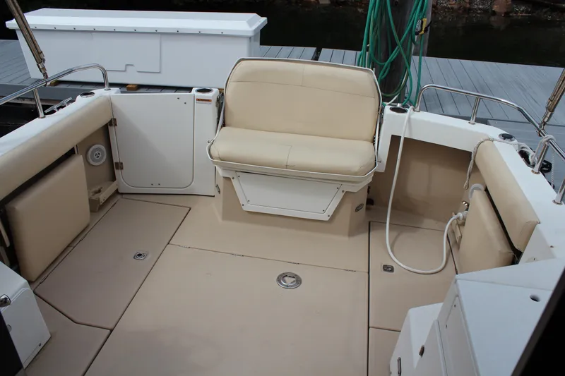Slide: The Image of 2013 Cutwater 28 LE boat interior with beige seating and deck. - 13