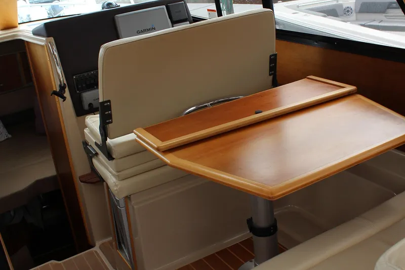 Slide: The Image of 2013 Cutwater 28 LE interior with wooden table and Garmin navigation system. - 16