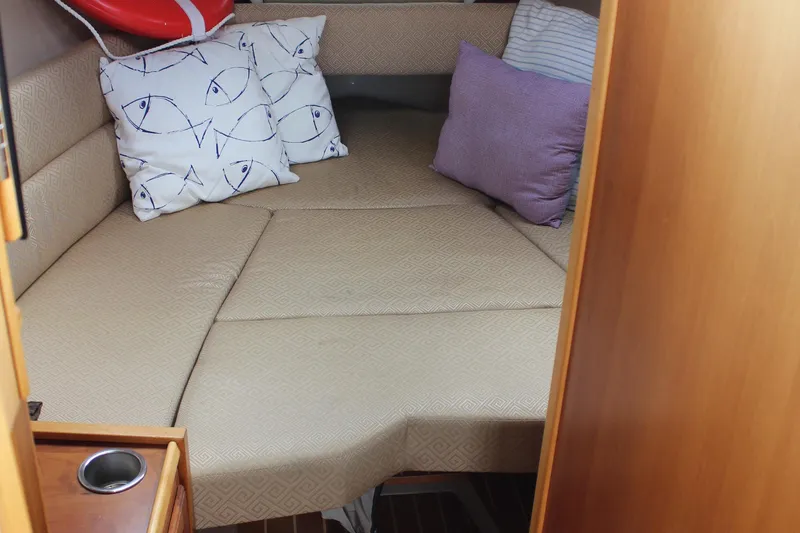 Slide: The Image of Cozy cabin interior of 2013 Cutwater 28 LE with patterned cushions and pillows. - 18