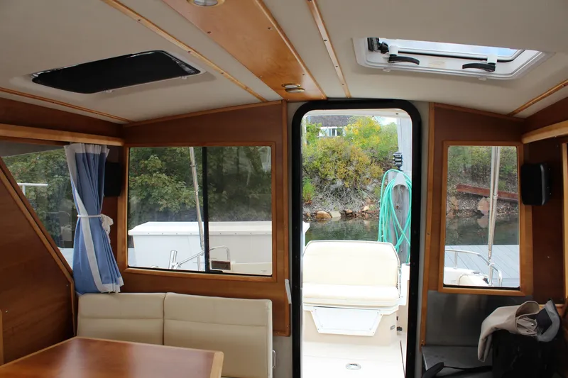 Slide: The Image of Interior view of 2013 Cutwater 28 LE boat with seating and windows. - 22