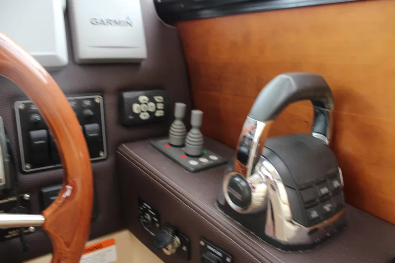 Slide: The Image of 2013 Cutwater 28 LE helm with Garmin controls and wooden steering wheel. - 27