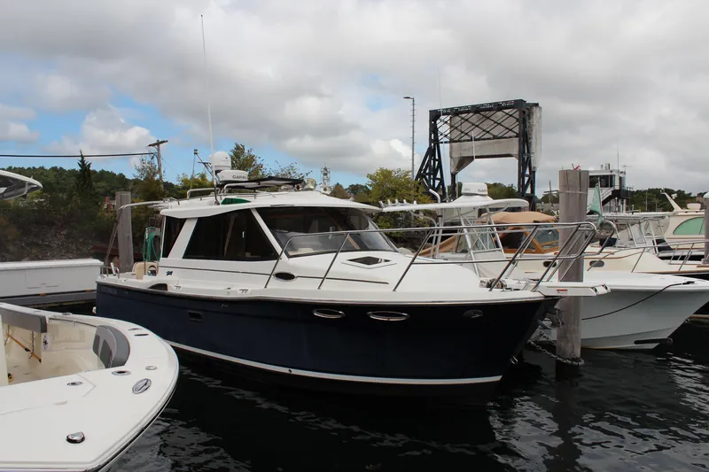Slide: The Image of 2013 Cutwater 28 LE boat docked at a marina under cloudy skies. - 3