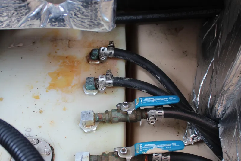 Slide: The Image of Close-up of 2013 Cutwater 28 LE boat plumbing with hoses and valves. - 35