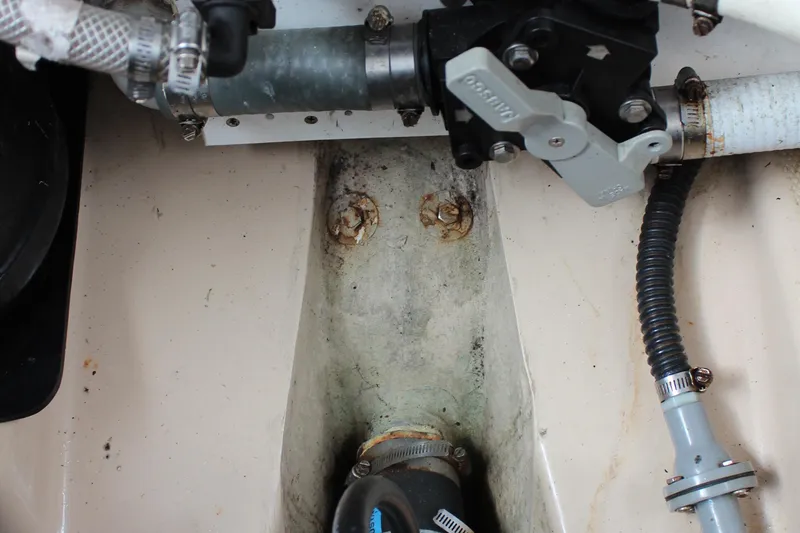 Slide: The Image of Engine compartment of a 2013 Cutwater 28 LE boat showing hoses and mechanical components. - 38