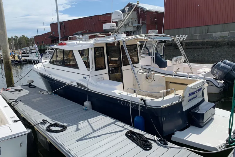 Slide: The Image of 2013 Cutwater 28 LE boat docked at marina, featuring sleek design and modern equipment. - 4