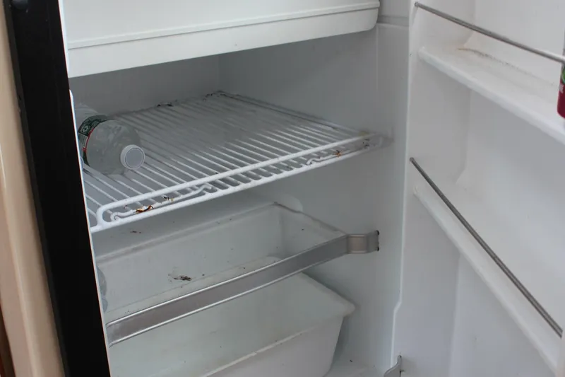 Slide: The Image of Empty refrigerator interior with a single water bottle, Cutwater 28 LE, 2013 model. - 42