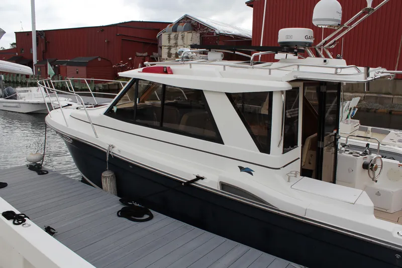 Slide: The Image of 2013 Cutwater 28 LE boat docked near red buildings, side view. - 5