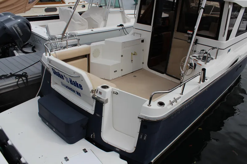 Slide: The Image of 2013 Cutwater 28 LE boat docked, featuring spacious deck and sleek design. - 6