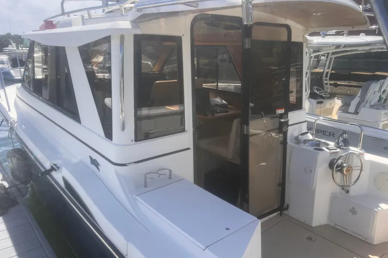 Slide: The Image of 2013 Cutwater 28 LE boat docked, showcasing cabin and helm area. - 8