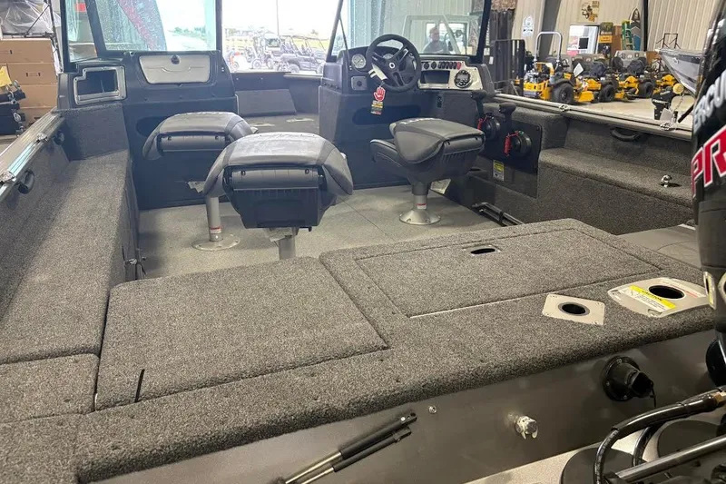 Slide: The Image of 2024 Lund 1875 Impact XS boat interior with seating and control console. - 3