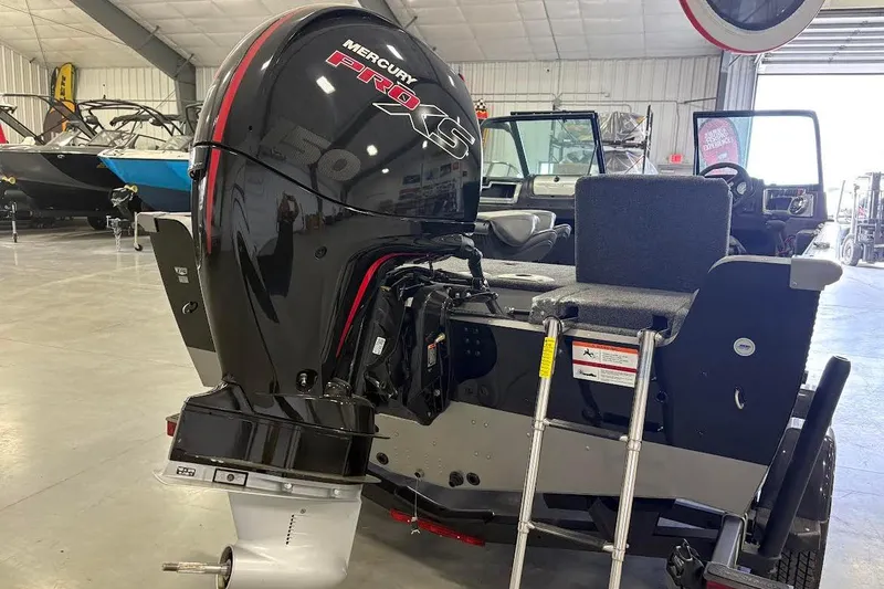 Slide: The Image of 2024 Lund 1875 Impact XS boat with Mercury Pro XS engine in showroom. - 4