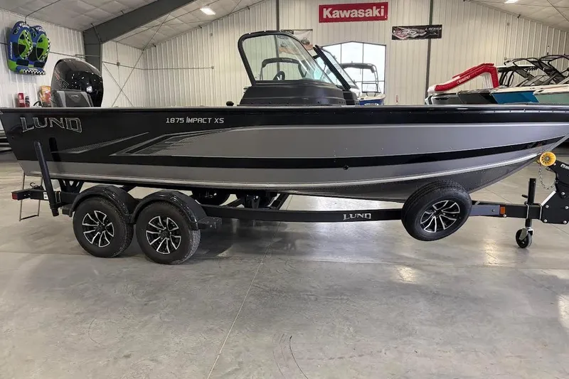 Slide: The Image of 2024 Lund 1875 Impact XS boat on trailer in showroom. - 5