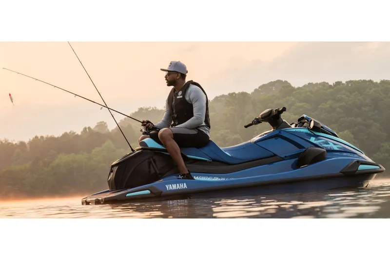 Slide: The Image of 2026 Yamaha WaveRunner VX Cruiser on a serene lake, person fishing at sunrise. - 6