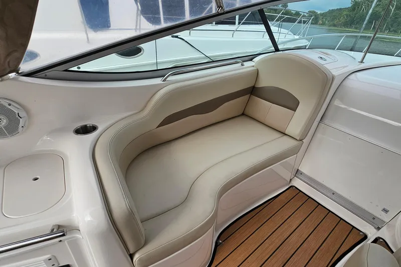 Slide: The Image of 2004 Chaparral Signature 310 boat interior with beige seating and wood flooring. - 11