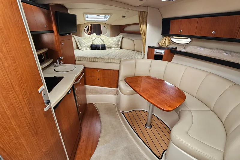 Slide: The Image of 2004 Chaparral Signature 310 cabin interior with kitchenette, seating, and sleeping area. - 16