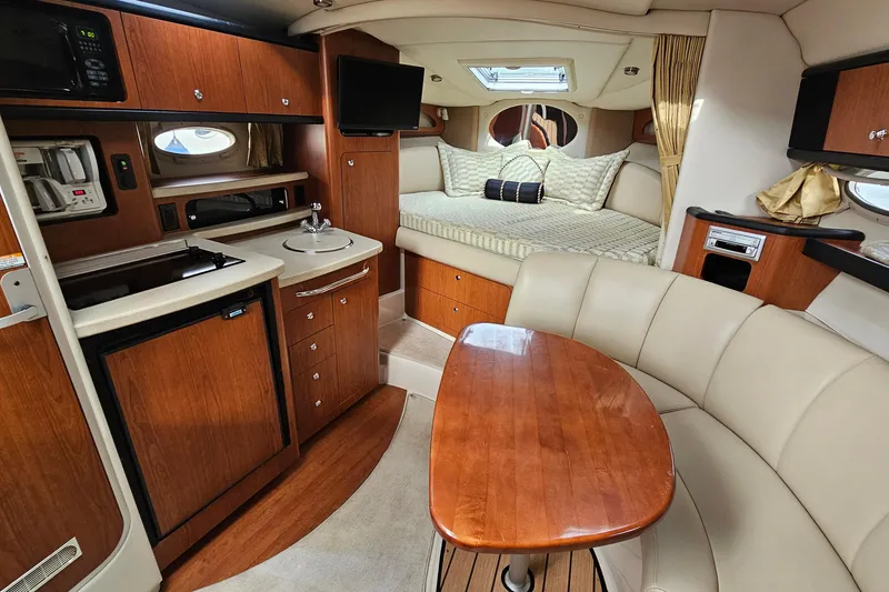 Slide: The Image of Luxurious 2004 Chaparral Signature 310 yacht interior with kitchenette, seating, and sleeping area. - 17
