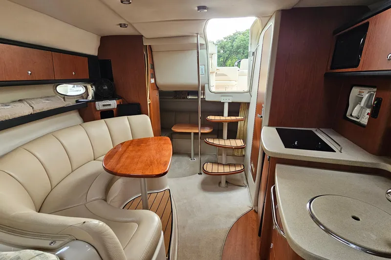 Slide: The Image of Luxurious interior of 2004 Chaparral Signature 310 yacht with elegant seating and kitchenette. - 22