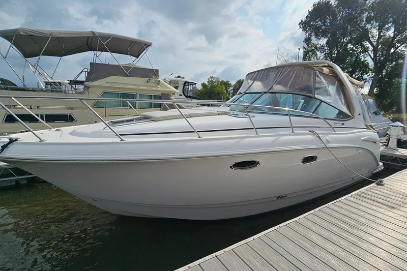Slide: The Image of 2004 Chaparral Signature 310 boat docked at marina under cloudy sky. - 3
