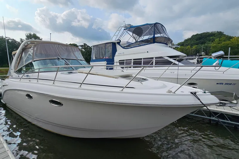 Slide: The Image of 2004 Chaparral Signature 310 boat docked, featuring sleek design and spacious deck. - 4