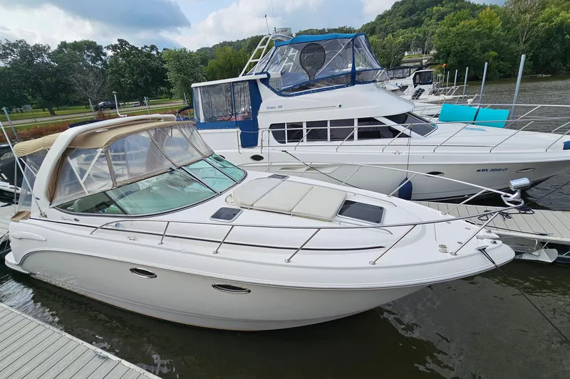 Slide: The Image of 2004 Chaparral Signature 310 boat docked beside another vessel on a calm river. - 5