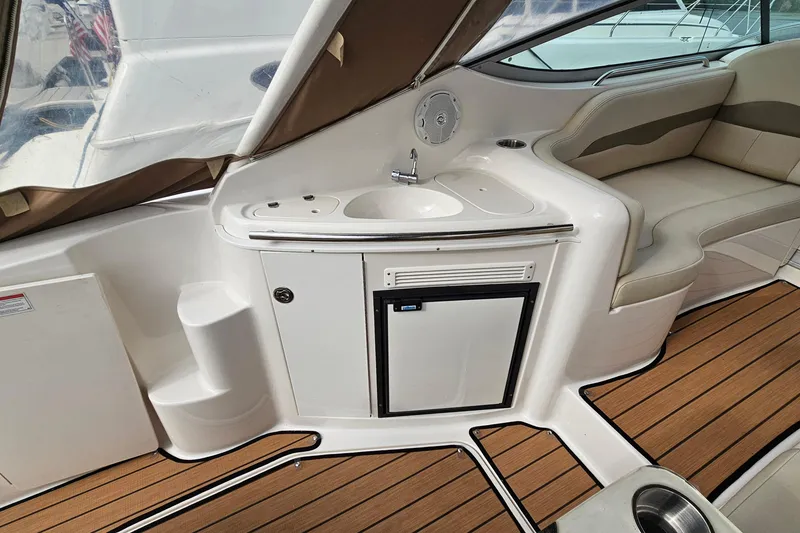 Slide: The Image of 2004 Chaparral Signature 310 boat interior with kitchenette and seating area. - 9