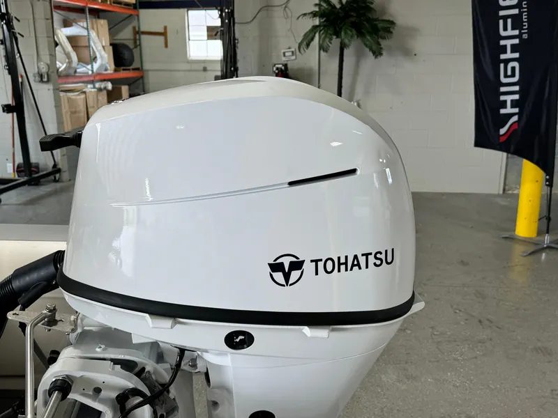 Slide: The Image of Tohatsu outboard motor on 2024 Highfield Classic 380 Grand Tour boat in showroom. - 21