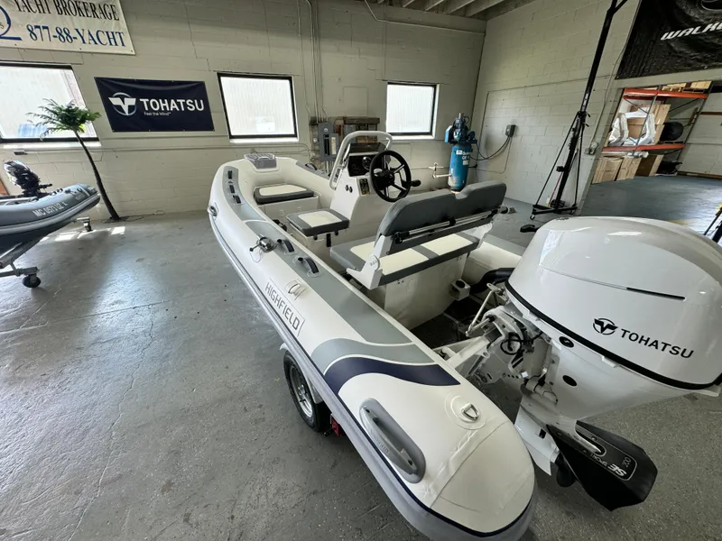 Slide: The Image of 2024 Highfield Classic 380 Grand Tour boat with Tohatsu engine in showroom. - 8