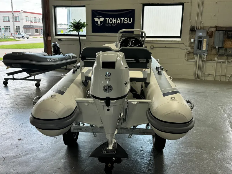 Slide: The Image of 2024 Highfield Classic 380 Grand Tour boat in showroom with Tohatsu engine. - 9