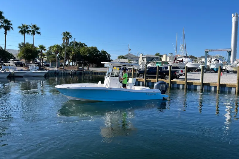 The Image of 2026 Caymas 24 HB boat in showroom, light blue hull, on a trailer. - 0