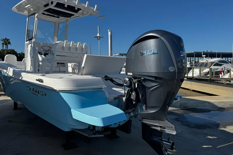 Slide: The Image of 2026 Caymas 24 HB boat docked at marina under clear blue sky. - 10