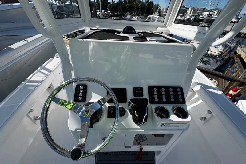 Slide: The Image of 2026 Caymas 24 HB boat helm with steering wheel and control panel. - 20