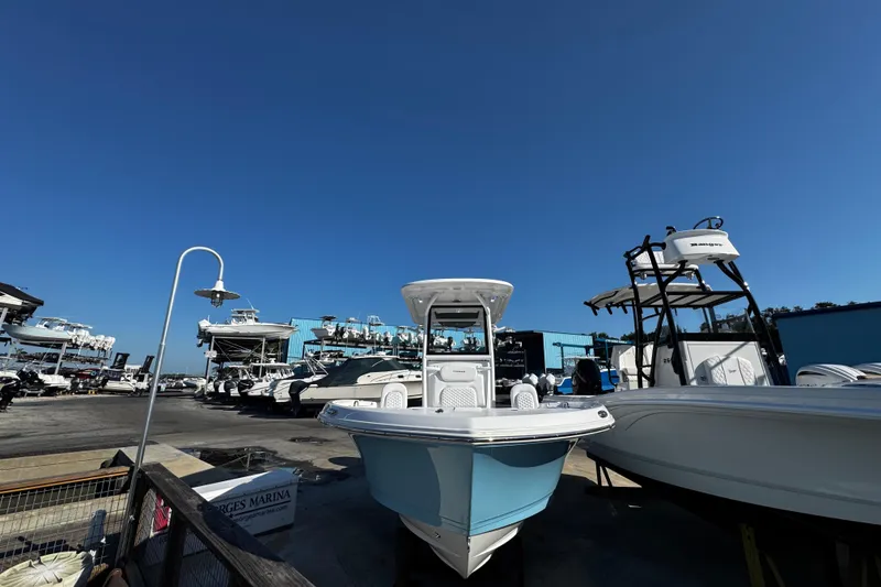 Slide: The Image of 2026 Caymas 24 HB boat in sunlight, docked with clear blue sky background. - 8