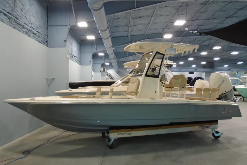 The Image of 2026 Scout 231 XSB boat displayed in a showroom with modern interior design. - 11