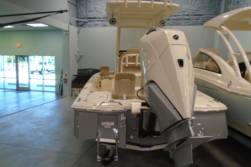 Slide: The Image of 2026 Scout 231 XSB boat with outboard motor in showroom. - 13