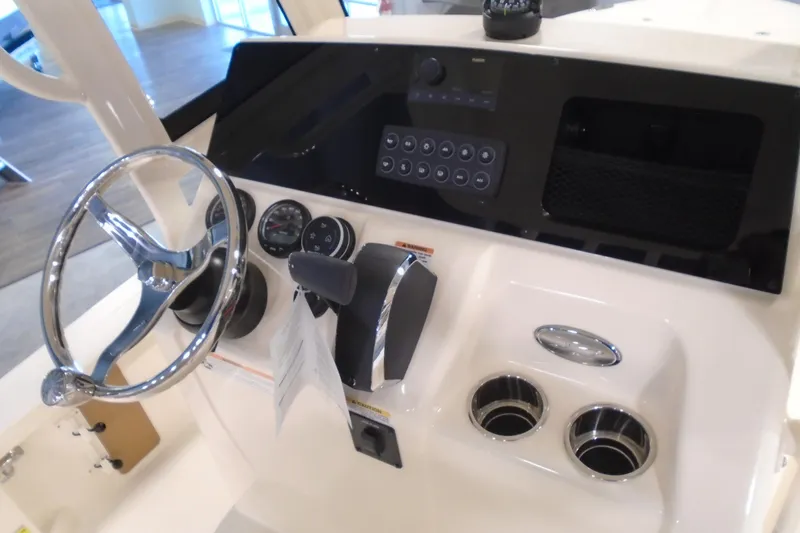 Slide: The Image of 2026 Scout 231 XSB boat dashboard with steering wheel and control panel. - 20