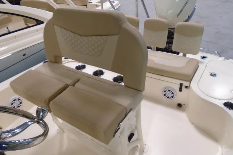 Slide: The Image of 2026 Scout 231 XSB boat interior with beige seating and steering wheel. - 24