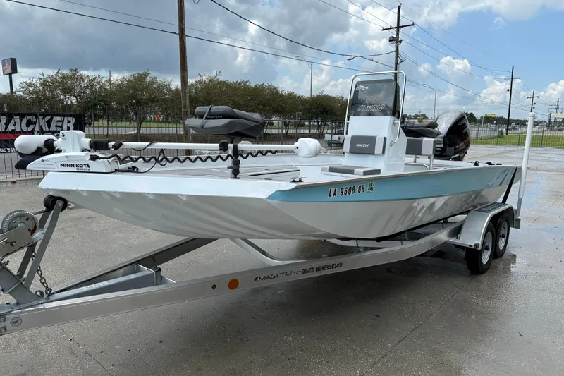 Slide: The Image of 2024 Alweld 2070cc boat on trailer, featuring Minn Kota trolling motor. - 3