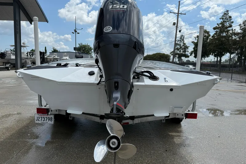 Slide: The Image of 2024 Alweld 2070cc boat with powerful outboard motor, parked on a trailer. - 5