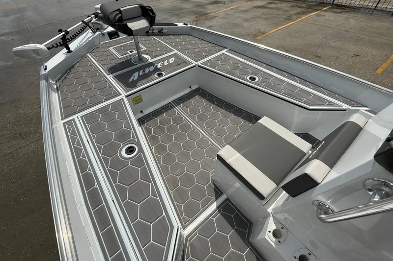 Slide: The Image of 2024 Alweld 2070cc boat interior with hexagonal patterned flooring and seating. - 8