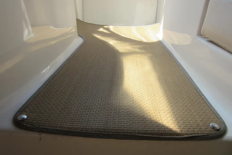 Slide: The Image of Interior view of 2000 Chaparral Signature 300 boat with beige carpet flooring. - 11