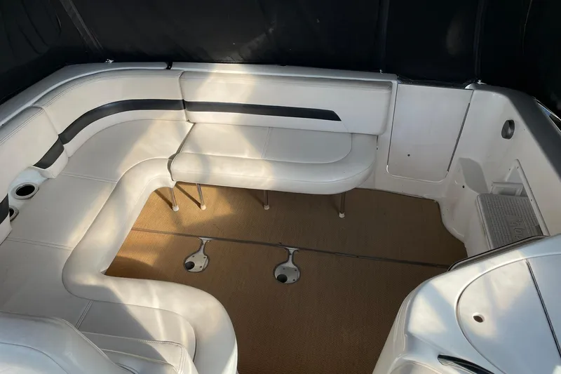 Slide: The Image of 2000 Chaparral Signature 300 boat interior with white seating and carpeted floor. - 12