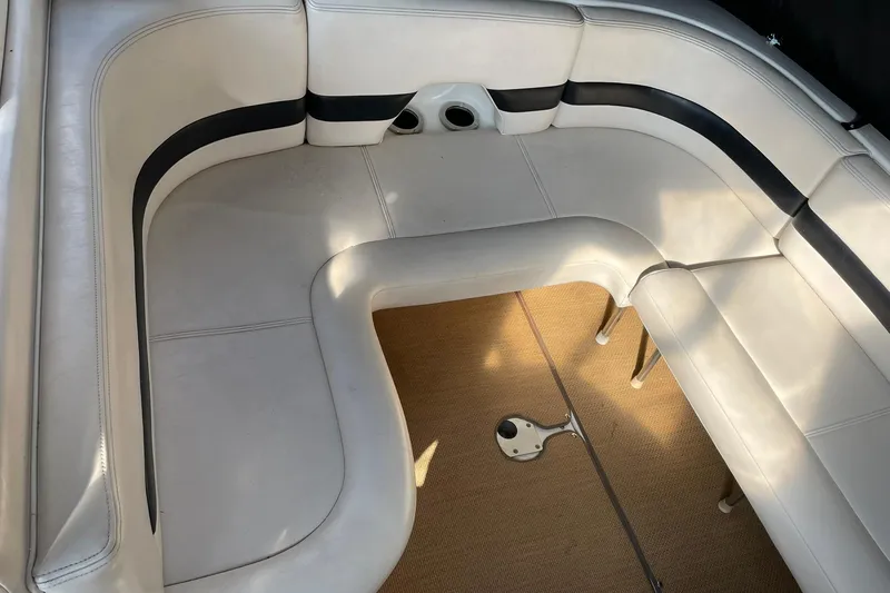Slide: The Image of Interior seating of 2000 Chaparral Signature 300 boat, featuring white and black upholstery. - 13