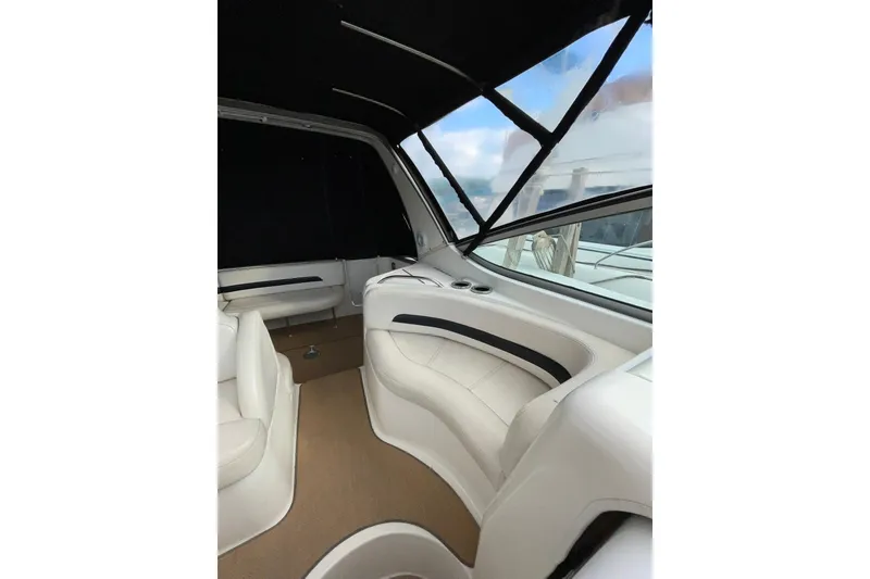 Slide: The Image of Interior of 2000 Chaparral Signature 300 boat with white seating and black canopy. - 14