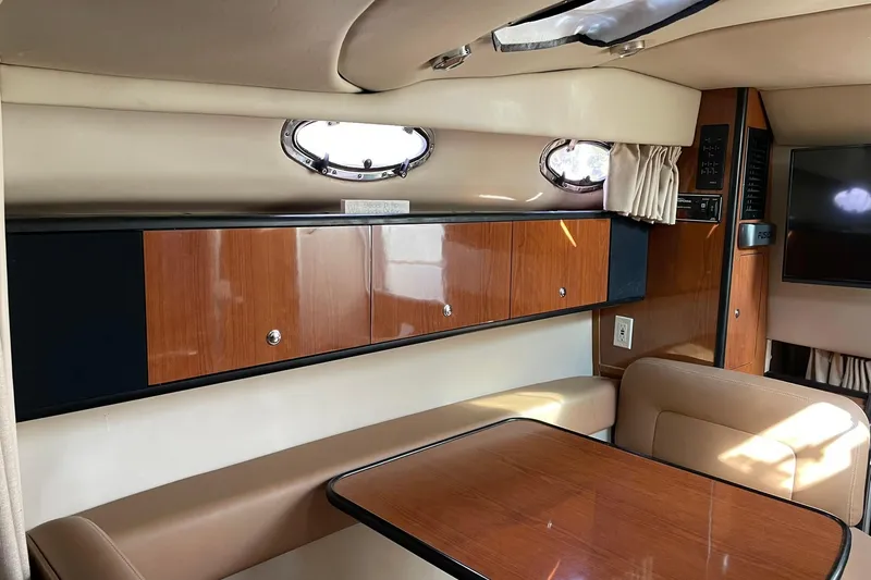 Slide: The Image of Interior of 2000 Chaparral Signature 300 yacht with wood cabinetry and seating area. - 19