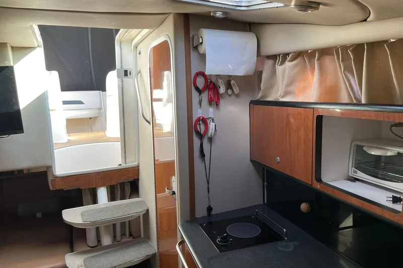 Slide: The Image of Interior of 2000 Chaparral Signature 300 boat with kitchen and seating area. - 20