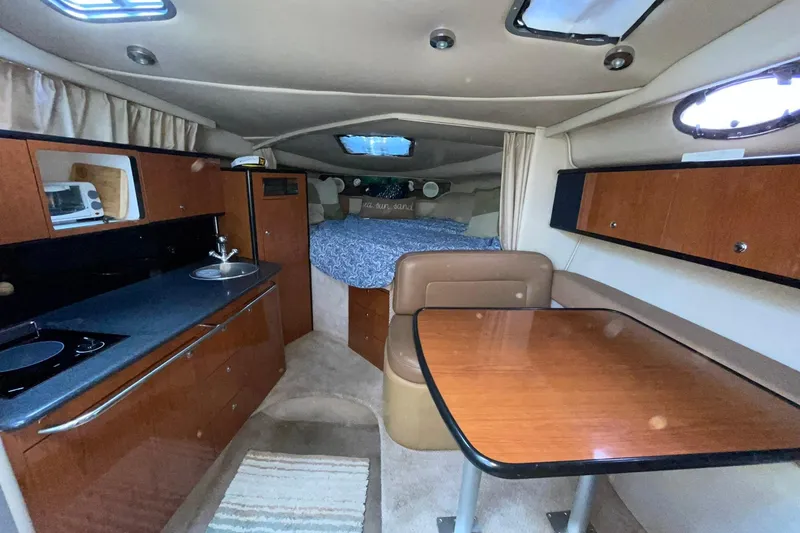 Slide: The Image of Interior of 2000 Chaparral Signature 300 boat with kitchen and dining area. - 21