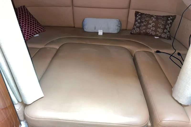 Slide: The Image of Interior cabin of 2000 Chaparral Signature 300 with beige seating and decorative pillows. - 23