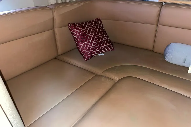 Slide: The Image of Interior seating of 2000 Chaparral Signature 300 with brown leather and decorative pillows. - 24